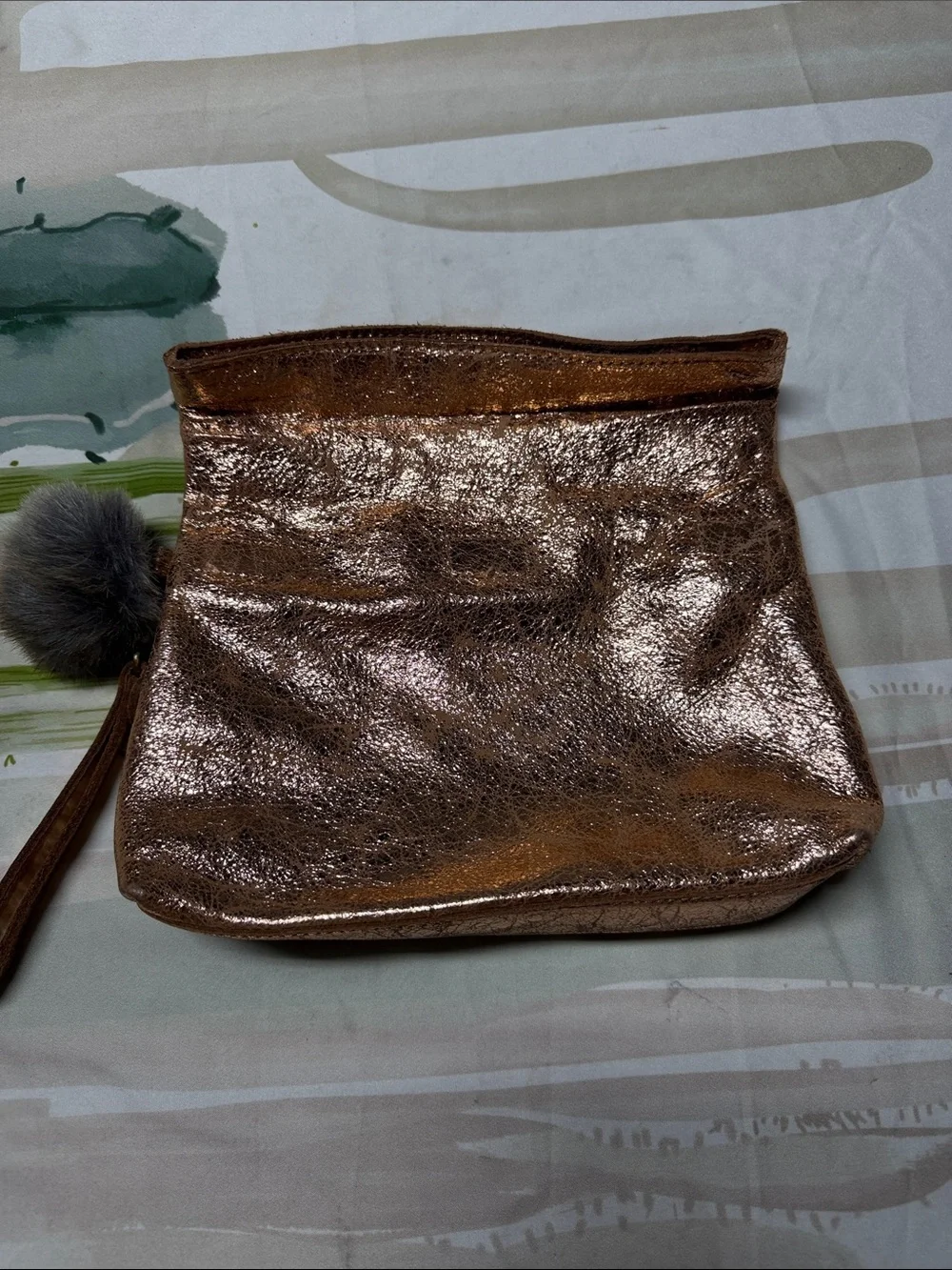 Miss Albright Metallic Rose Gold Wristlet Clutch with Pom Pom Accent